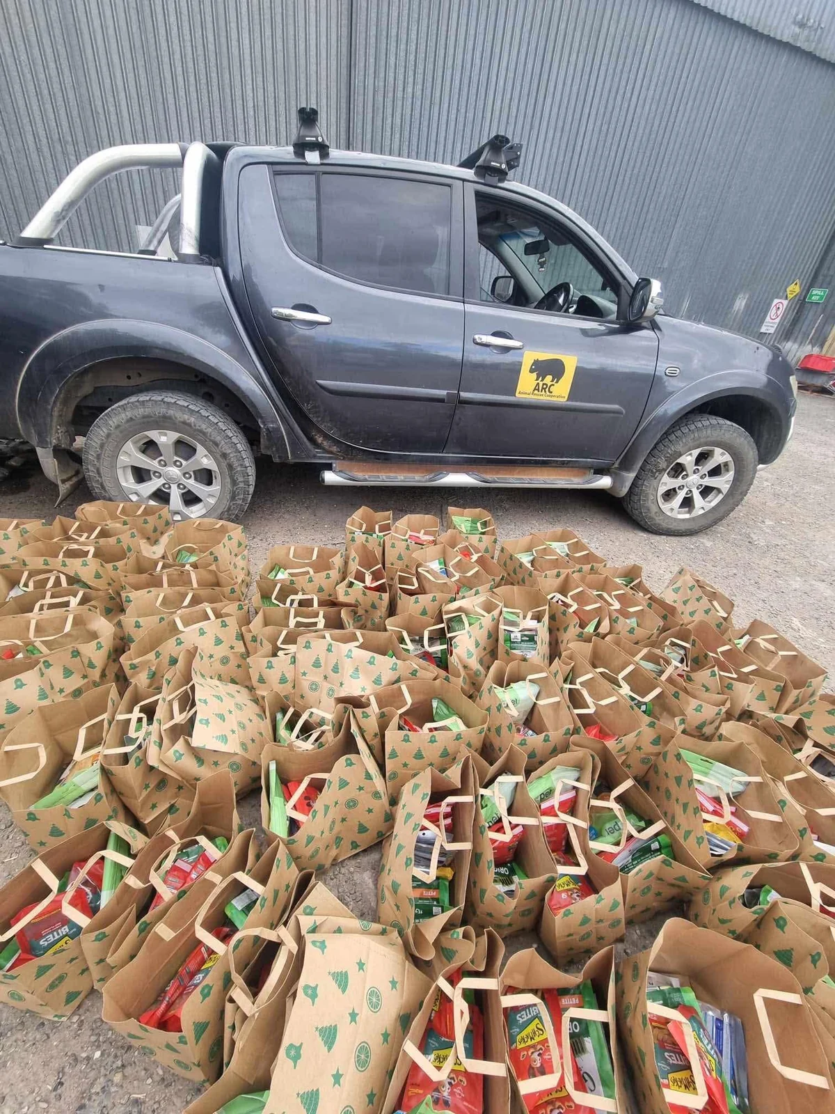 Donation bags arranged beside an ARC ute