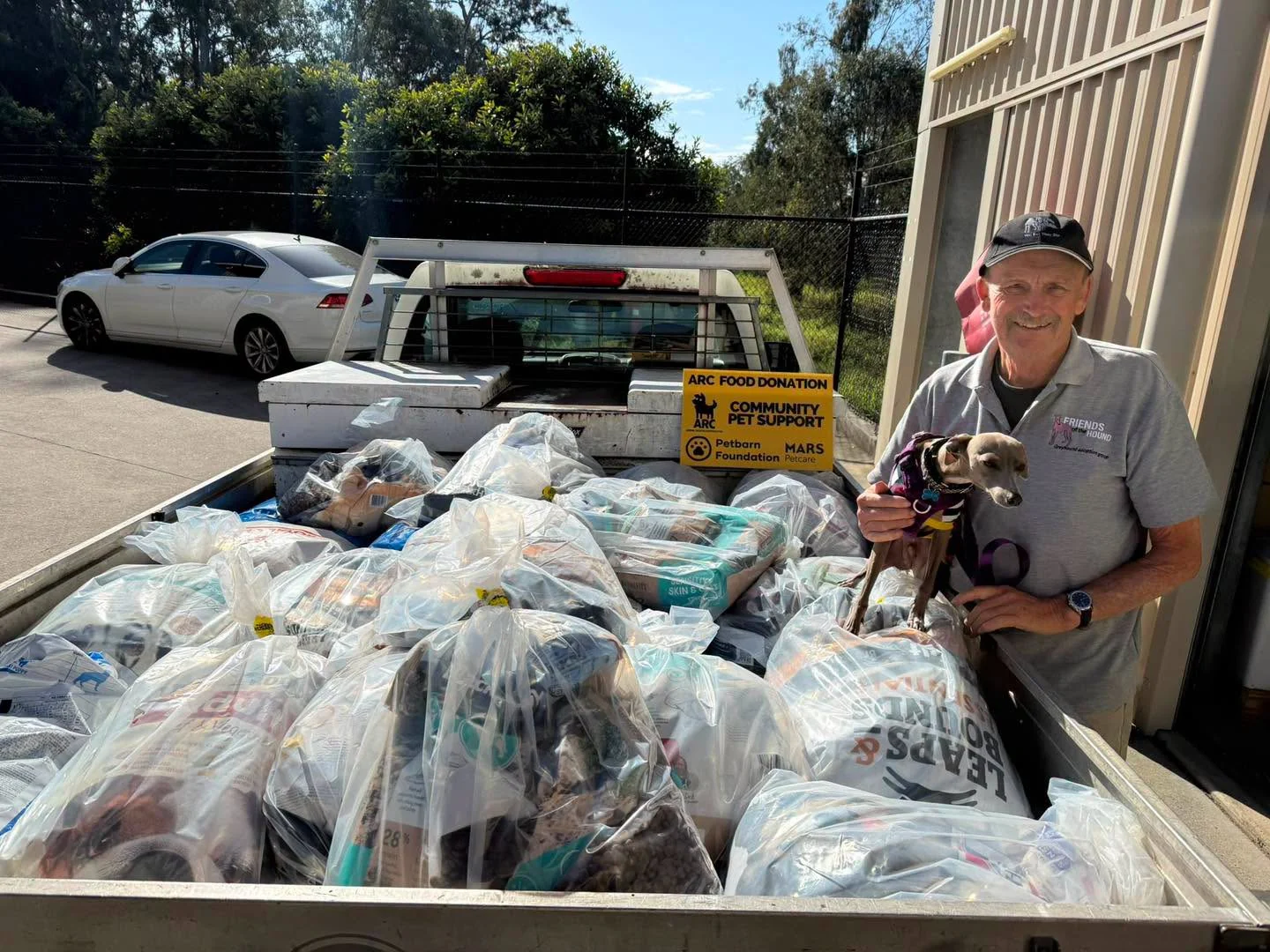 A greyhound and donated supplies collected through ARC Brisbane