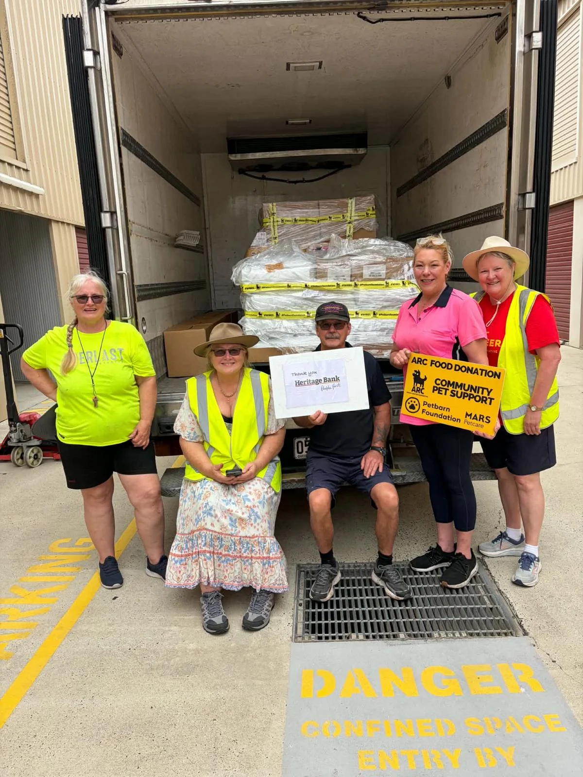 Brisbane team beside a truck loaded with donated supplies