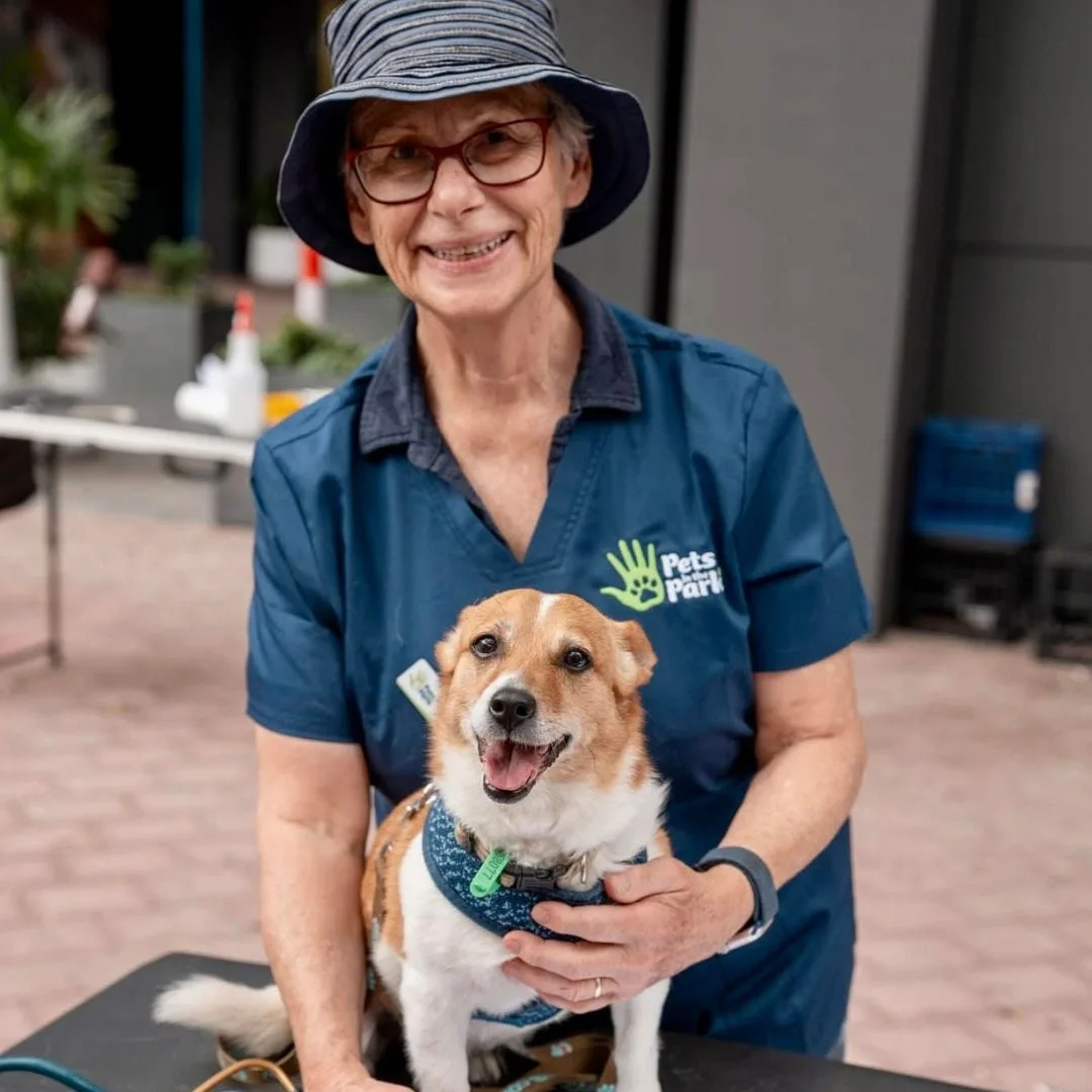 A smiling carer with a dog
