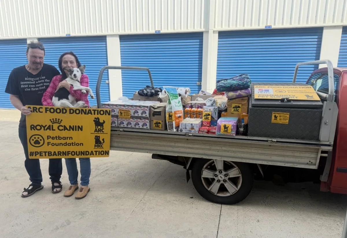 People beside a ute loaded with pet food and ARC donation signs